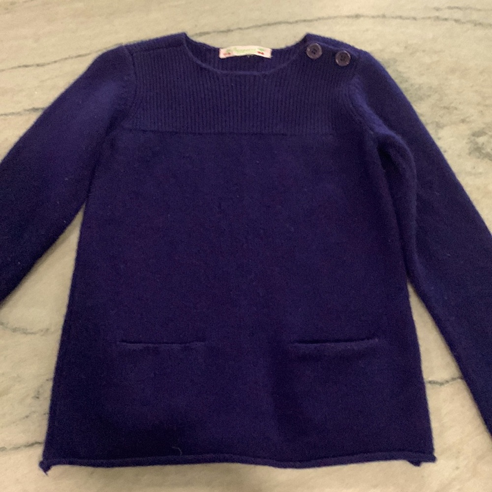 Cashmere sweater with cute button detail and 2 front pockets.